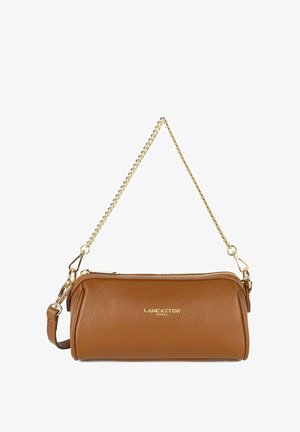 Brown leather handbag with textured finish, gold chain strap, zipper closure, and subtle branding on front. Compact cylindrical shape.