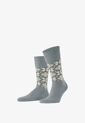 Chaussettes grises avec un motif à flocons de neige de couleur crème et des accents. Poignet côtelé et texture lisse.