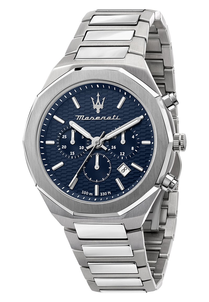 Stålanalog klocka med en blå texturerad urtavla, silverdetaljer och kronografsubdials. Har en oktagonal klockkapsel och armband i metallkedja.