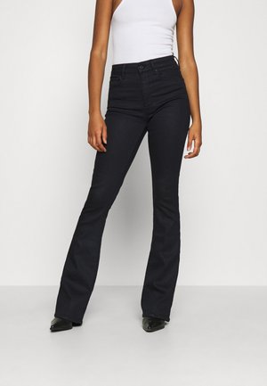 Flared Jeans - coated denim