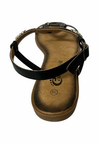 Sandalias negras con suela plana, con una delgada correa en el tobillo y adornos de rhinestone decorativos en la parte superior. Talla 38 marcada en la plantilla.