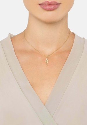 Gold snake pendant necklace on a thin chain, hung at the collarbone, with a smooth texture and a minimalist design.