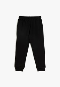Schwarze Sweatpants aus weichem Material, mit einem elastischen Bund und schmalen Bündchen an den Knöcheln. Einfaches und klassisches Design.