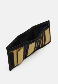 Black fabric wallet with a zip closure, featuring yellow interior pockets and card slots arranged in vertical sections.