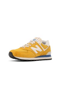 Yellow suede sneaker with white accents, mesh toe box, and gray heel. Features gray laces and a blue midsole. Model number 574 visible.