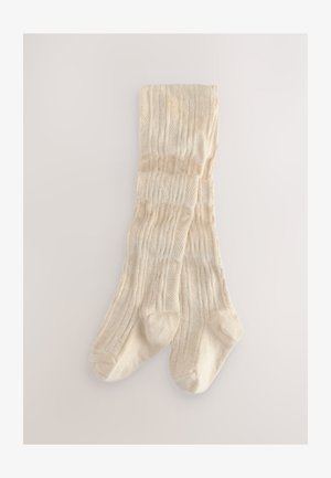 Térdig érő zokni krémszínben, bordázott textúrával és szőtt mintákkal, puha kötött anyagból készült.