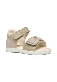 Sandali beige con tacco in suede texturizzato e dettaglio a fiocco. Cinghia regolabile per una vestibilità perfetta. Suola leggera con design perforato per traspirabilità.
