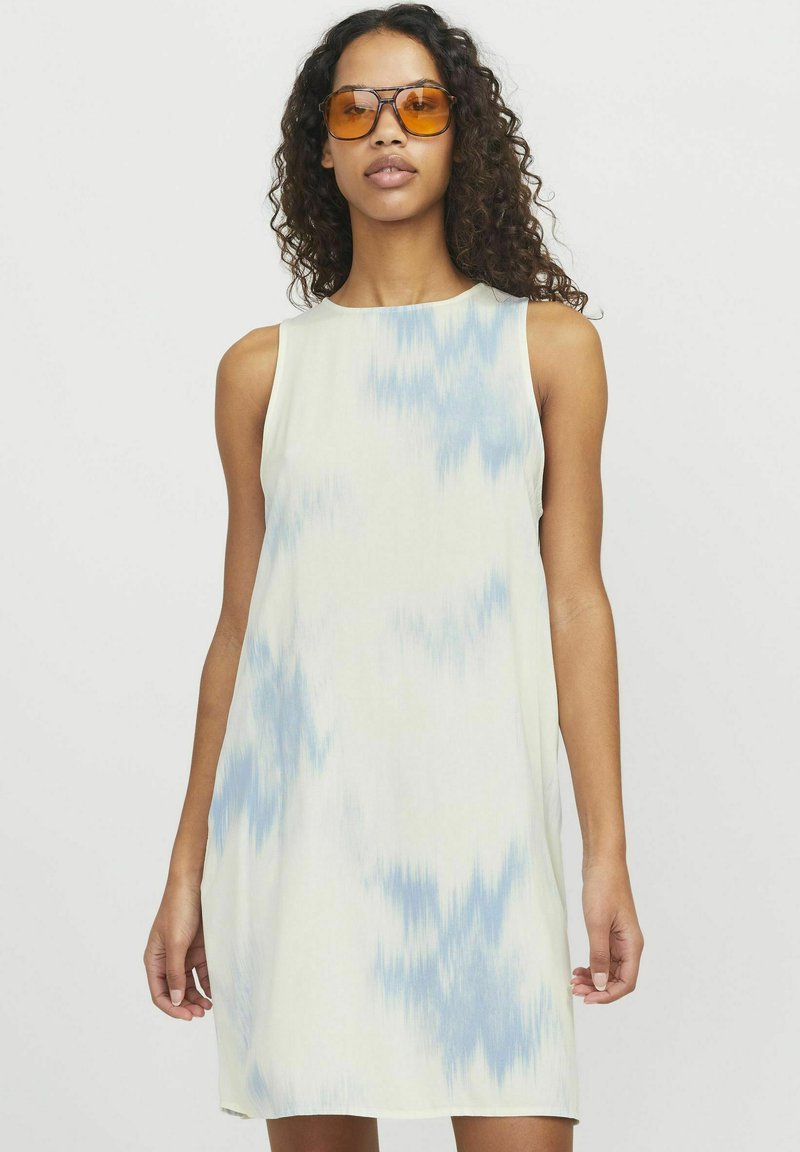 Ärmlös klänning i mjukt tyg med en krämfärgad botten och blå batikmönster, med en avslappnad passform och rund halsringning.