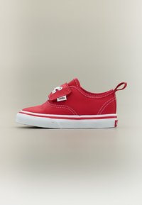 Baskets rouges pour tout-petit de la marque Vans avec semelle en caoutchouc blanche, sangle à scratch et languette de traction sur fond neutre.