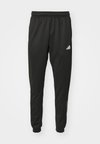 ESSENTIALS CAMOUFLAGE - Tracksuit bottoms - black