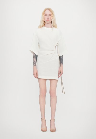 White short dress made of a textured, lightweight fabric, featuring a twisted design on the hip and wide sleeves. Accented with a rope detail.