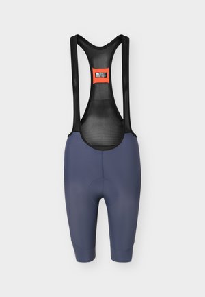 Cuissard de cyclisme bleu marine avec bretelles en maille noire et étiquette orange sur la partie supérieure du dos, présenté sur un fond blanc.