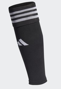 Manica nera per gamba realizzata in tessuto liscio ed elasticizzato. Presenta un bordo in rilievo con tre strisce bianche e un accento con logo bianco.