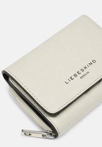 Portefeuille en cuir gris clair avec une finition texturée, doté d'une fermeture éclair et d'un logo en relief "LIEBESKIND BERLIN" en noir.