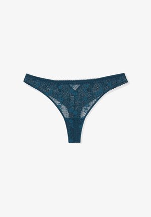 Lace thong in dark teal featuring floral patterns and scalloped edges, with a thin waistband and minimal rear coverage. Lightweight fabric.