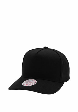 Black fitted baseball cap with curved brim and round red and white sticker on front left side of the brim.