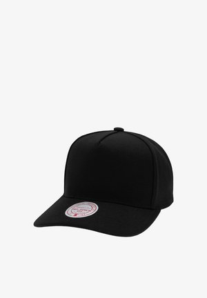 Black fitted baseball cap with curved brim and round red and white sticker on front left side of the brim.