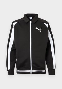 Μαύρο αθλητικό μπουφάν με φερμουάρ, με λευκές ρίγες στα μανίκια, λευκό λογότυπο Puma στο στήθος και λεπτομέρειες με λευκές ρίγες στο τελείωμα.