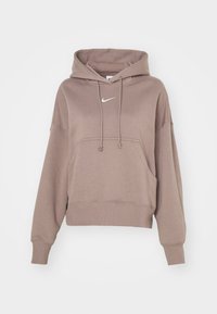 Ljusbrun kort hoodie med långa ärmar, framficka, snörning och en liten vit Nike swoosh-logotyp på bröstet.