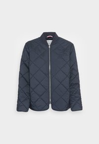 Marineblå quiltet jakke med lynlåjsfront, ribbet krave og elastiske manchetter. Har et diskret præget logo på brystet.