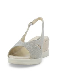 Sandalo a zeppa in beige chiaro con tomaia in tessuto testurizzato, punta aperta, design incrociato e cinturino alla caviglia regolabile. Suola in gomma bianca.