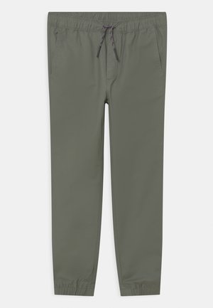 Pantalon décontracté vert olive avec taille à cordon, poches latérales et poignets élastiques, posé à plat sur fond blanc.