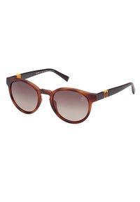 Occhiali da sole con gradiente marrone e montatura rotonda e oversize. Realizzati in acetato leggero con bracci neri a contrasto e accento del logo.