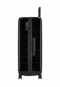 Valigia rigida nera con scanalature orizzontali, serratura a combinazione e manico telescopico. Quattro ruote scorrevoli per una mobilità facile.