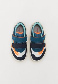Blue and white athletic shoes with orange accents, featuring double Velcro straps, mesh texture, and a cushioned insole.