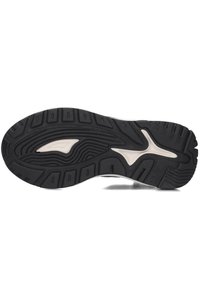 Black rubber sneaker sole with textured patterns and grooves; central white accent. Durable material designed for grip and stability.