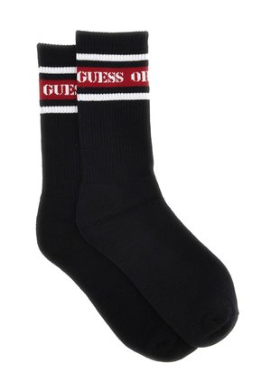 Calzini neri con texture a coste e una fascia rossa e bianca in cima, con la scritta "GUESS" in rosso.
