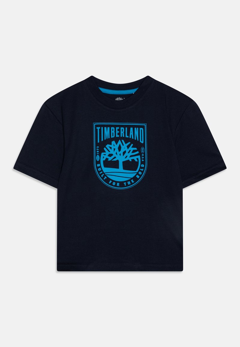 T-shirt de algodão azul-marinho com gola redonda, apresentando um logótipo turquesa da Timberland e um gráfico de árvore no centro. Mangas curtas; corte relaxado.