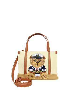 Borsa beige e marrone con due manici, una tracolla staccabile e un orsacchiotto vestito da marinaio con la scritta "Rue Madame Paris".