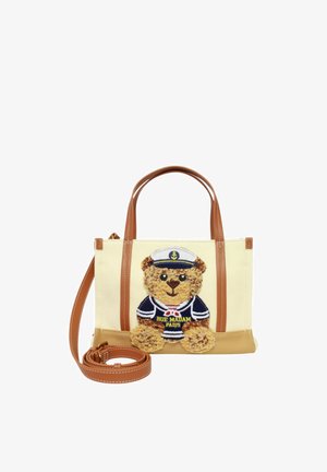Borsa beige e marrone con due manici, una tracolla staccabile e un orsacchiotto vestito da marinaio con la scritta "Rue Madame Paris".