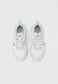 Ζευγάρι λευκών παπουτσιών για τρέξιμο Under Armour Charged Commit με κορδόνια, φαίνεται από πάνω σε απλό λευκό φόντο.