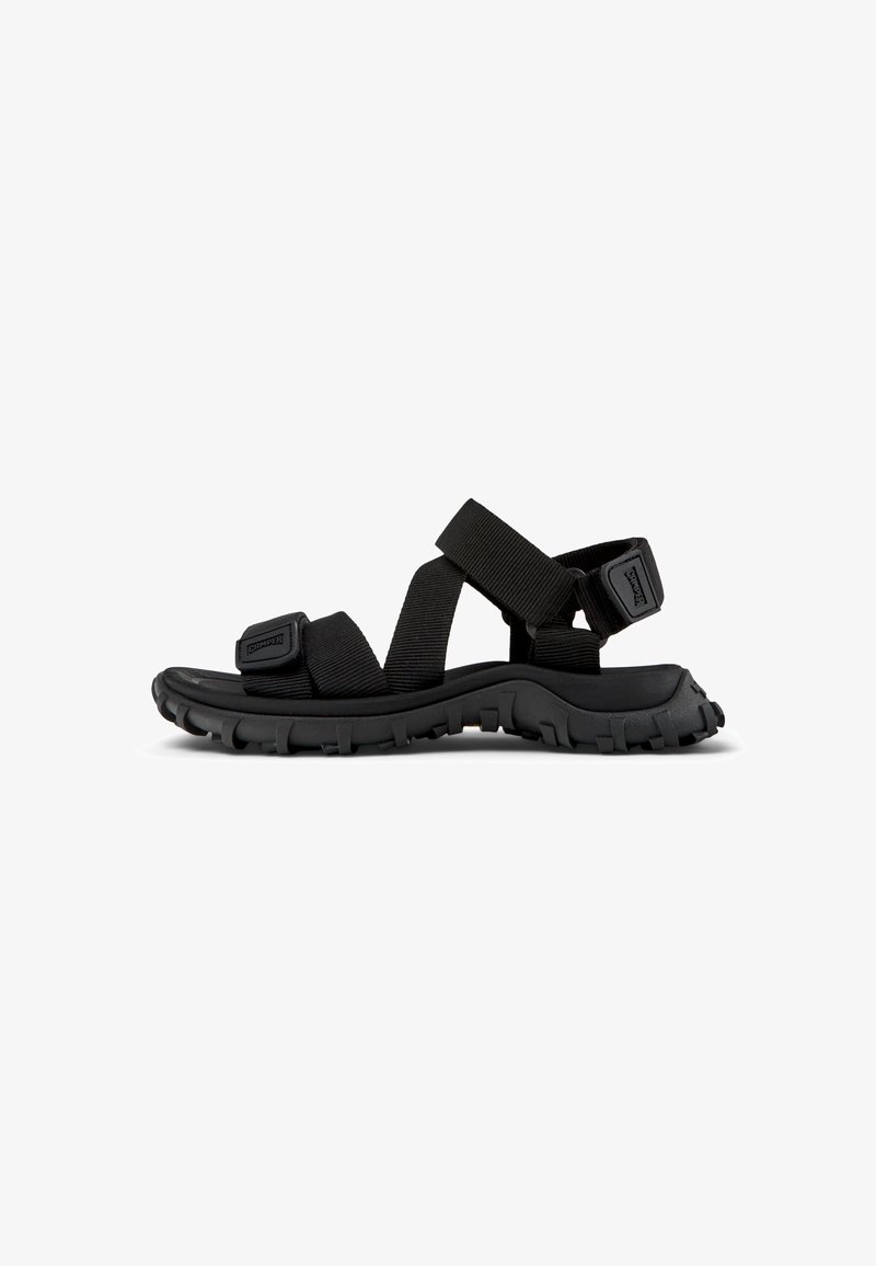 Black outdoor sandals with thick rubber soles, adjustable fabric straps, and a textured surface; designed for comfort and durability.