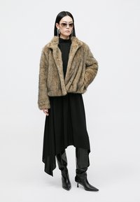 Brown faux fur jacket, black high-low dress, black knee-high boots, sleek sunglasses, long earrings, smooth texture, modern design.