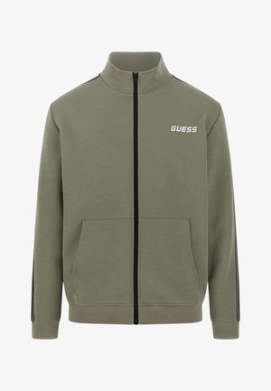 Sudadera verde oliva con cremallera, hecha de mezcla de algodón. Cuenta con un cuello alzado, dos bolsillos frontales y franjas negras contrastantes en las mangas.
