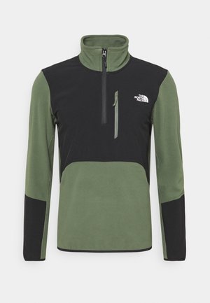 Puolivetoketjullinen fleece-pullover oliivinvihreänä ja mustana, jossa on rintatasku, korkea kaulus ja kontrastiväriset paneelit. Pehmeä rakenne ja kestävä muotoilu.