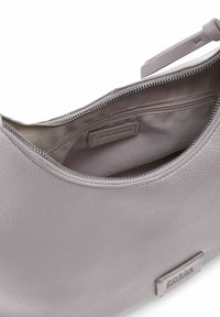 Lichtgrijze leren tas met een gladde textuur, ritssluiting en een subtiel binnenzakje. Voorzien van een logotag aan de buitenkant.