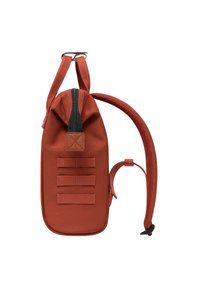 Red canvas backpack with a cylindrical shape, a zipper closure, three horizontal straps, and adjustable padded shoulder strap.