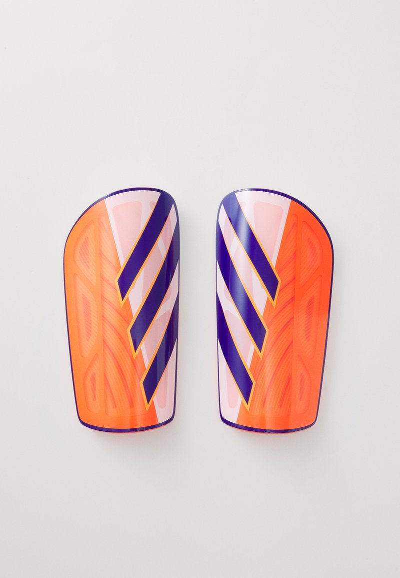 Orange and purple soccer shin guards with a textured surface, featuring diagonal stripes and a sleek, contoured design.