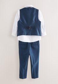 White long-sleeve shirt with navy blue tailored vest and matching trousers, displayed from the back on a neutral background.