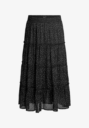 Schwarzer Stufen-Midirock mit weißen Punkten, gerafftem Bund und Rüschen an den Nähten, aus leichtem, durchsichtigem Stoff.