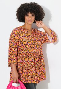 Mehrfarbige Bluse in orange, pink und schwarzem abstraktem Muster. Mit V-Ausschnitt, 3/4 Ärmeln und einem gerafften unteren Saum.