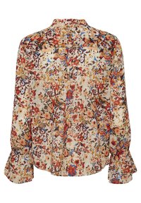 Blusa de estampado floral con mangas largas, que presenta una base crema con toques en rojo, azul y amarillo. Está confeccionada en una tela ligera y fluida.
