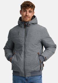 Gray padded jacket with a hood, featuring a textured fabric, zippered pockets, and brown leather accents. Solid color with ribbed cuffs.