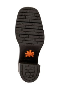 Czarna podeszwa buta z wzorem cegieł, z wyraźnym pomarańczowym logo w kształcie gwiazdy oraz teksturowanymi detalami zwiększającymi przyczepność i trakcję.