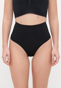Black high-waisted bikini bottom with smooth texture and moderate coverage, featuring a classic cut and elastic waistband.