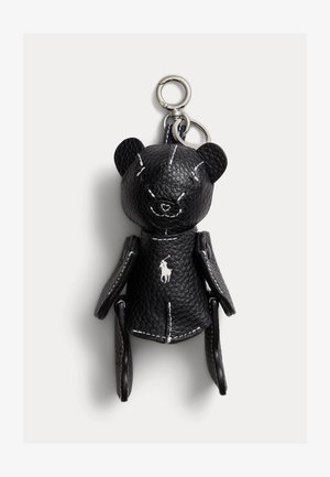Black textured leather bear keychain with silver rings and white stitched detailing, featuring a small white polo player logo on its chest.